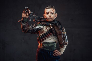 Youth survivor with gun in rags pose in dark background