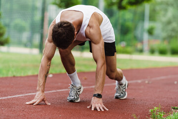 Young white runner working out on playground outdoors