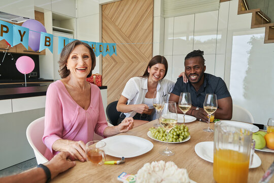 Smiling mother talking with father at kitchen