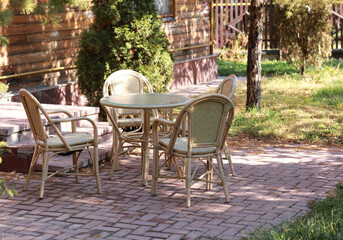 a table with chairs in the summer garden