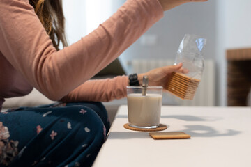woman having breakfast in the morning cookies with milk a continental breakfast at home