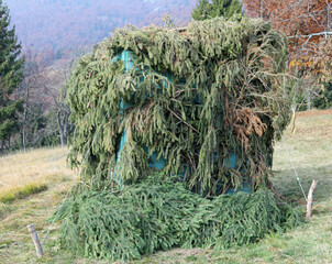 hunting lodge of hunters camouflaged with leaves to hide from the sight of birds