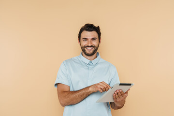 White bristle man smiling and using tablet computer