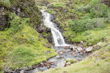 Fototapeta na wymiar Waterfall in the mountains of Scotland