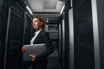 Young engineer businesswoman in network server room