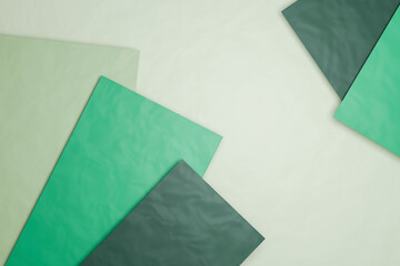 Three dimensional render of green sheets of paper against pastel green background