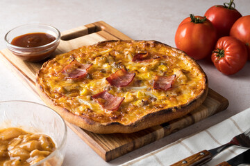 Cheese, bacon, onion, chicken and bbq sauce pizza