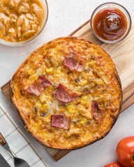 Overview of cheese, bacon, onion, chicken and bbq sauce pizza