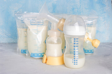 Bags with breast milk. Breast pump on yellow background. Milk bank. Expressing breast milk....