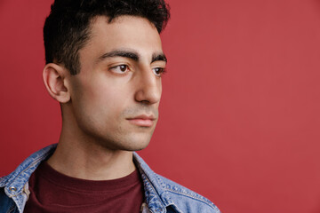 Young middle eastern man posing and looking aside