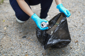 Volunteer charity woman hand holding garbage black bag and plastic bottle garbage for recycling for cleaning at park volunteering concept reuse and volunteer helping
