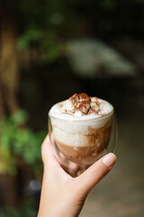 Woman hands  holding cup of coffee with latte art. holding cup of tea or coffee in the morning
