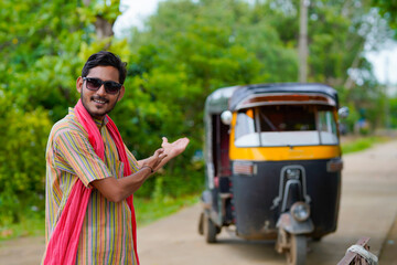 Indian auto rickshaw three-wheeler tuk-tuk taxi driver man.