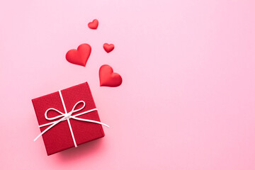 Valentine's Day. Gifts in the form of hearts on a pink background with the inscription love. Copy space for text. The concept of romance and love.