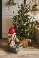 Little boy and Christmas tree, natural decor.