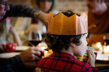 Little boy wearing a paper crown