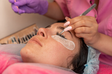 Eyelash extension procedure. Woman eye with long eyelashes. lashes, close up, macro, selective...
