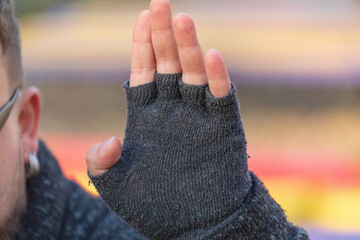 Gesture with the palm of the hand attached to the ear. The man is listening to something