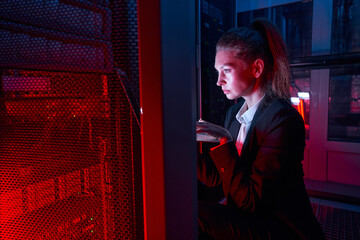 Woman administrator checking equipment in data center
