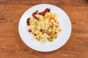 Casserole with pasta, sun-dried tomatoes on dish, top view