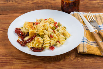 Portion of pasta casserole with supplemented sun-dried tomatoes