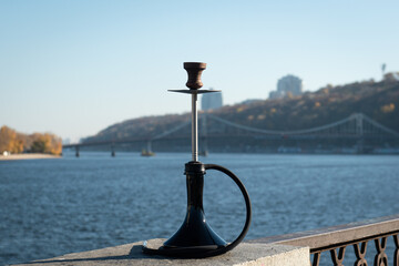 hookah sheesha with a glass flask and a clay bowl on the street. A traditional oriental getaway for relaxation