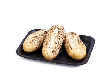 Three seeded rolls isolated on black tray on white background