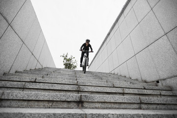 Woman freerider riding down city stairs