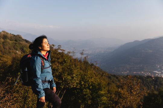 Woman with eyes closed on mountain
