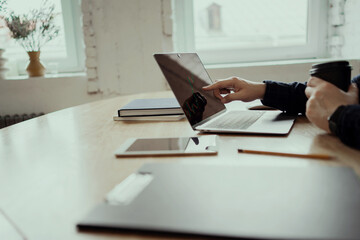 Fototapeta premium Trading on the financial securities exchange. The man works on the Internet. Workplace in the office. The laptop is open on the table.
