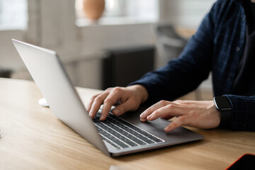 The laptop is open on the table. Online accounting of expenses in business. Workplace in the new...
