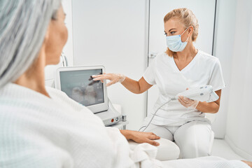 Competent salon worker consulting patient before procedure