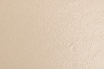 Beige textured concrete background with design space