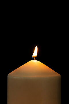 Burning candle light realistic flame, black background high resolution image