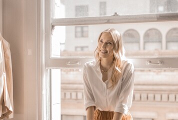 Smiling blonde businesswoman sitting on the balcony portrait