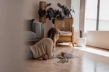 Brunette woman playing puzzles on the floor, hobby photo