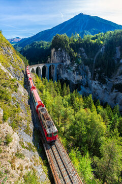 Switzerland, Graubunden Canton, Train crossing Landwasser Viaduct in summer