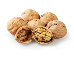 Whole and cracked walnuts on a white background