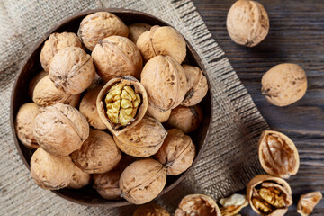Walnuts on a brown wooden background.