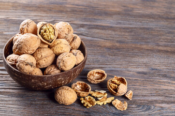 Walnuts on a brown wooden background