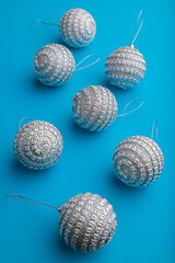 Christmas or New Year composition. Decorations, silver balls, on a blue background. Side view.