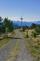 Dirt road to wind turbines in the grasslands of the Croatian mountains.