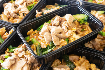 Modern Thai food lunch boxes in plastic packages.