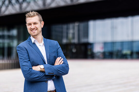 Smiling Male Professional Standing With Arms Crossed