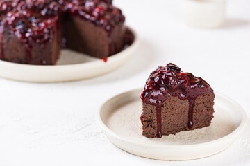 Eggplant chocolate pie with black currant confit on a plate. Sugar, gluten and lactose free, vegan.