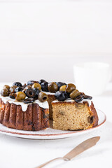 Homemade pie with green and black olives and lemon on a plate. Sugar, gluten and lactose free, vegan.