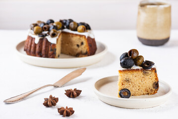 Vegan cake with green and black olives and lemon on a plate. Sugar, gluten and lactose free.