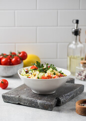 Eastern bulgur and vegetable tabbouleh salad in a plate. Vegetarian dish.