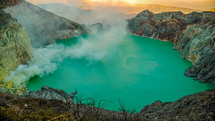 beautiful panoramic view of ijen crater at sunrise. sulfur fog billows over the turquoise lake into the air. kawah Ijen volcano, East Java, Indonesia.
