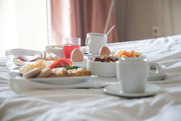 Breakfast tray in bed in hotel room